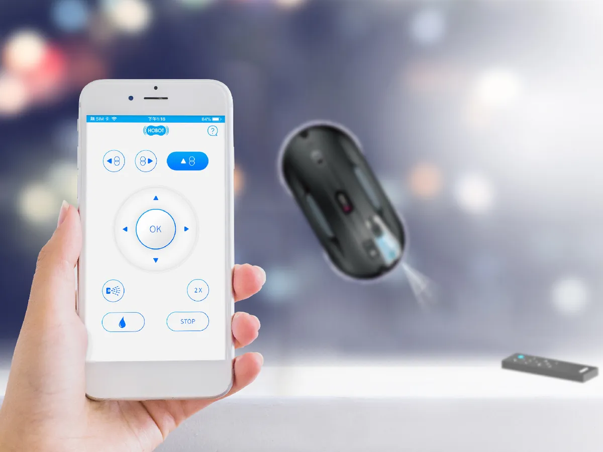 HOBOT 388 app on a smartphone, IR remote control and robot on glass